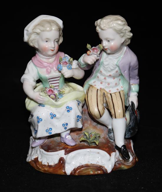 A Sitzendorf group of a boy and girl with flowers, 14cms